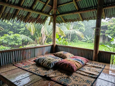 Open-air fale life in Samoa after rain, A sleeping mat and pillow in an open fal