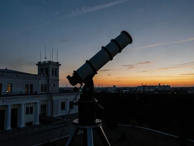 Telescope tracking mount silhouette at dusk