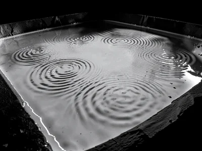 Liquid mercury pool showing subtle standing wave dimples