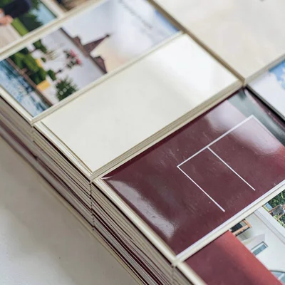 Folded paper composition mimicking glossy magazine covers in stacked grids, oxbl