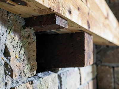 Beam end into masonry pocket