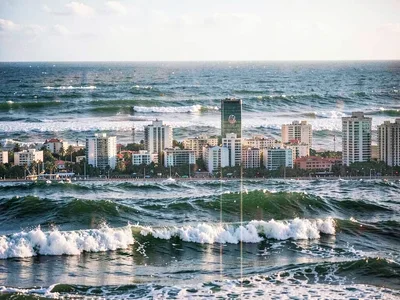 City with ocean waves overlaying