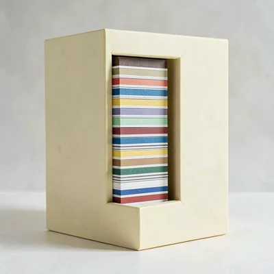 Vertical story-ratio composition of a stacked column of paint-chip cards in cabi