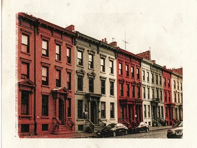 A row of brownstone buildings in warm red and black risograph, architectural det