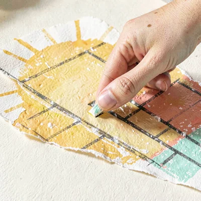 Small hand fitting a tab into a slot on a sunlit floor