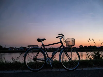 Bicycle parked against twilight gradient