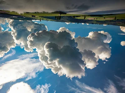 Cloud formation resembling landscape inverted in sky
