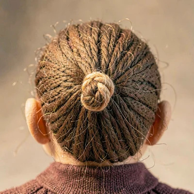 Texture study of yarn hair tied at the puppet's scalp, fine fiber loops