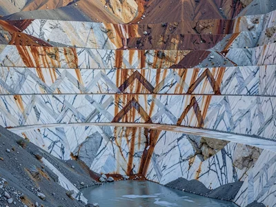 Rust stains flowing down quarry face from iron deposit