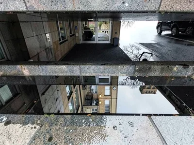 Metro entrance reflected in wet steps