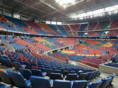 Empty stadium seats, the color pattern a wave frozen mid-crash