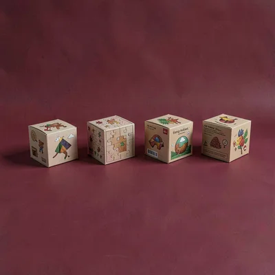 Lineup of four puzzle boxes stepping across a deep cranberry seamless, identical