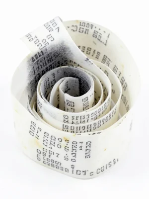 Very long CVS-style receipt coiled into a loose spiral, fading text creating gra