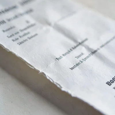 Macro of a folded resume page with rounded creases, soft light catching the deck