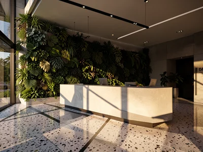 Modern office lobby with a reception desk, green living wall, and terrazzo floor