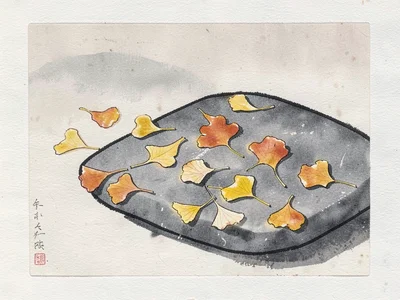 Autumn ginkgo leaves scattered on grey stone