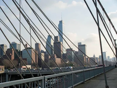 City skyline compressed behind bridge cables