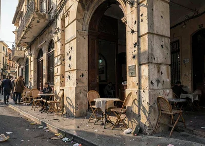 Mediterranean hard light on Beirut's wounded elegance, cafe chairs on sidewalk, 