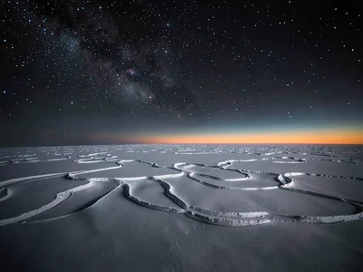 Wind-carved snow patterns under space-dark sky at 5000m