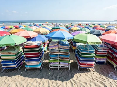 Beach umbrellas stacked in tight rows