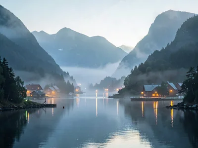 Village lights glowing through morning mist