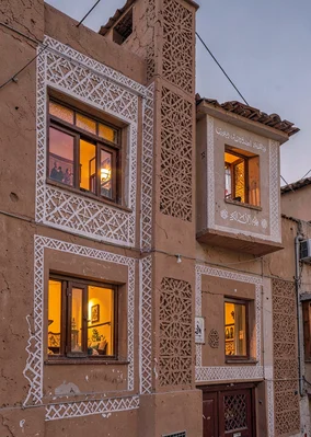 Colored light through qamariya windows in Sana'a, Yemen, gingerbread facade exte