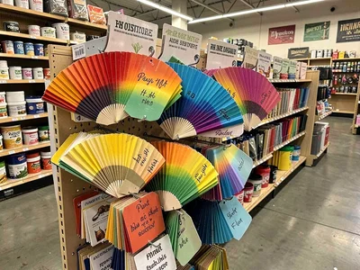 Paint chip rainbow, gradient samples in cardboard fans, every color named poetic