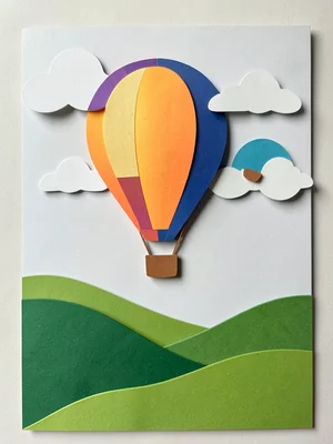 A hot air balloon scene: pale sky with cut-out cloud layers, three balloons at d