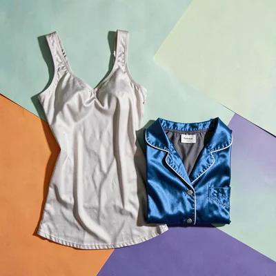 Tomas-blockcolor lookbook flatlay of a sleep gown next to a folded silk pajama s
