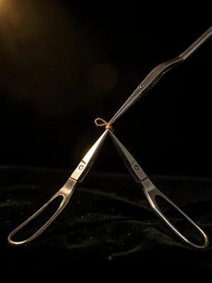 Forceps Holding Knot — Precision in Dark Field