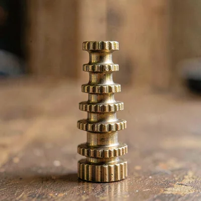 Vertical macro of a column of brass pinions arranged largest to smallest