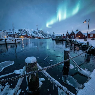 Polar night blue hour in Tromso, Norway, ice forming on harbor ropes and cleats,