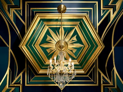 A ceiling coffer in gold and deep green, geometric patterns of nested chevrons, 