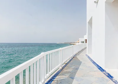 Extreme minimalist restraint of Muscat, Oman, corniche walkway with white railin