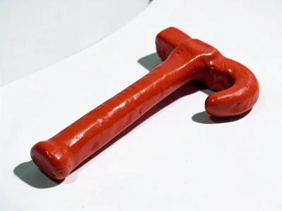 Robust chunky clay crowbar in cherry red with stubby curved hook and oversized s