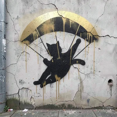 Parachuting cat figure stencilled on a cracked render wall, gold spray paint