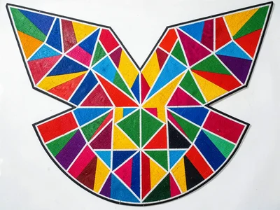 Beaded shoulder cape spread flat — symmetrical geometric wings, studio light