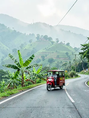 Emerald green hills through morning mist in Kigali, Rwanda, Motorcycle taxi (mot