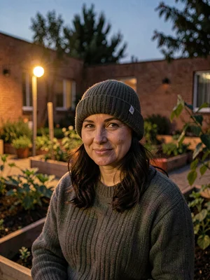 Lamp-lit portrait of a resident at a community garden plot in the courtyard, war