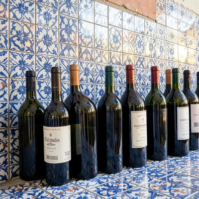 Azulejo tile geometry, Portuguese ceramic culture, Wine bottles lined up against