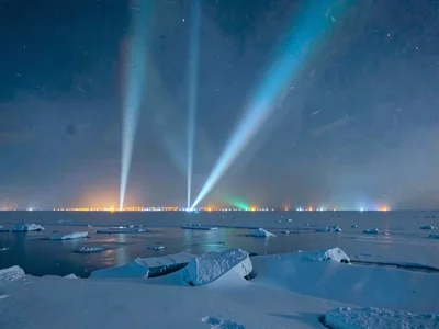 Light pillars from distant town lights in cold