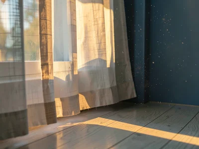 Linen curtain hem pooling on oak floor