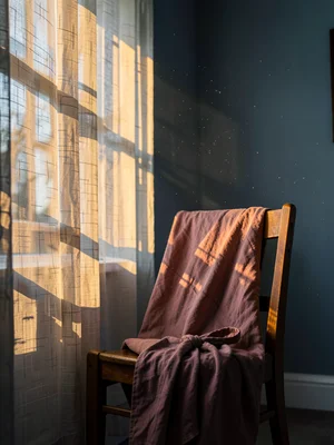 Dusty rose dressing gown in amber morning light
