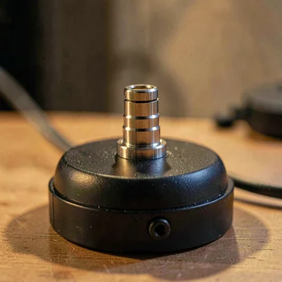 Edge-lit macro of an XLR connector pin layout on the base of a microphone, soft