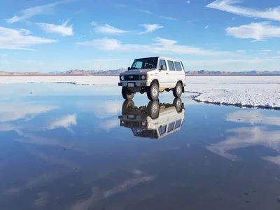 Vehicle appearing to float on reflected sky