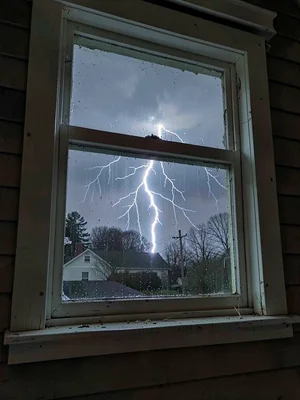 Window of house during storm, lightning somewhere behind the exposure