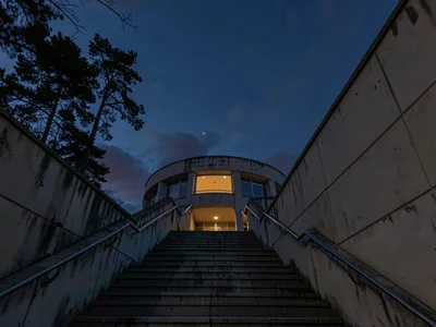 Observatory stairs ascending toward darkening sky
