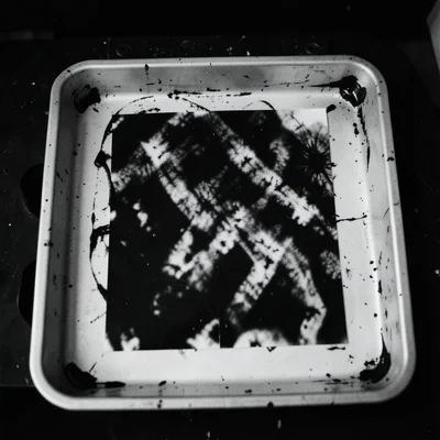 Developer tray marks: where the tray was rocked unevenly, creating abstract dark
