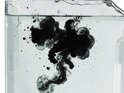 Black ink cloud expanding in clear water