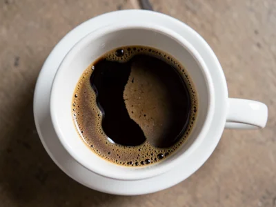 Coffee cup showing coffee evaporating in stages, full to dry ring, overhead view